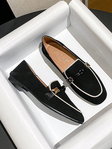 Black loafers with white piping