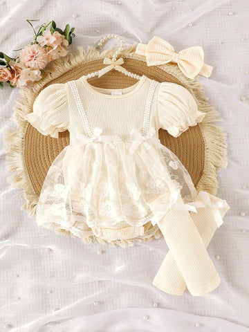 Baby cream romper for a wedding
