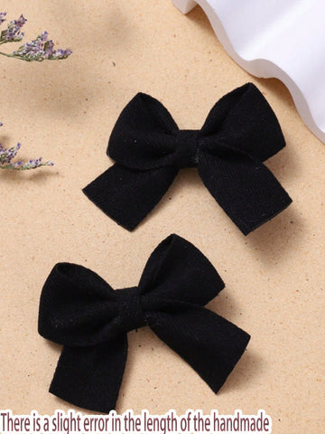 2 black bow clips